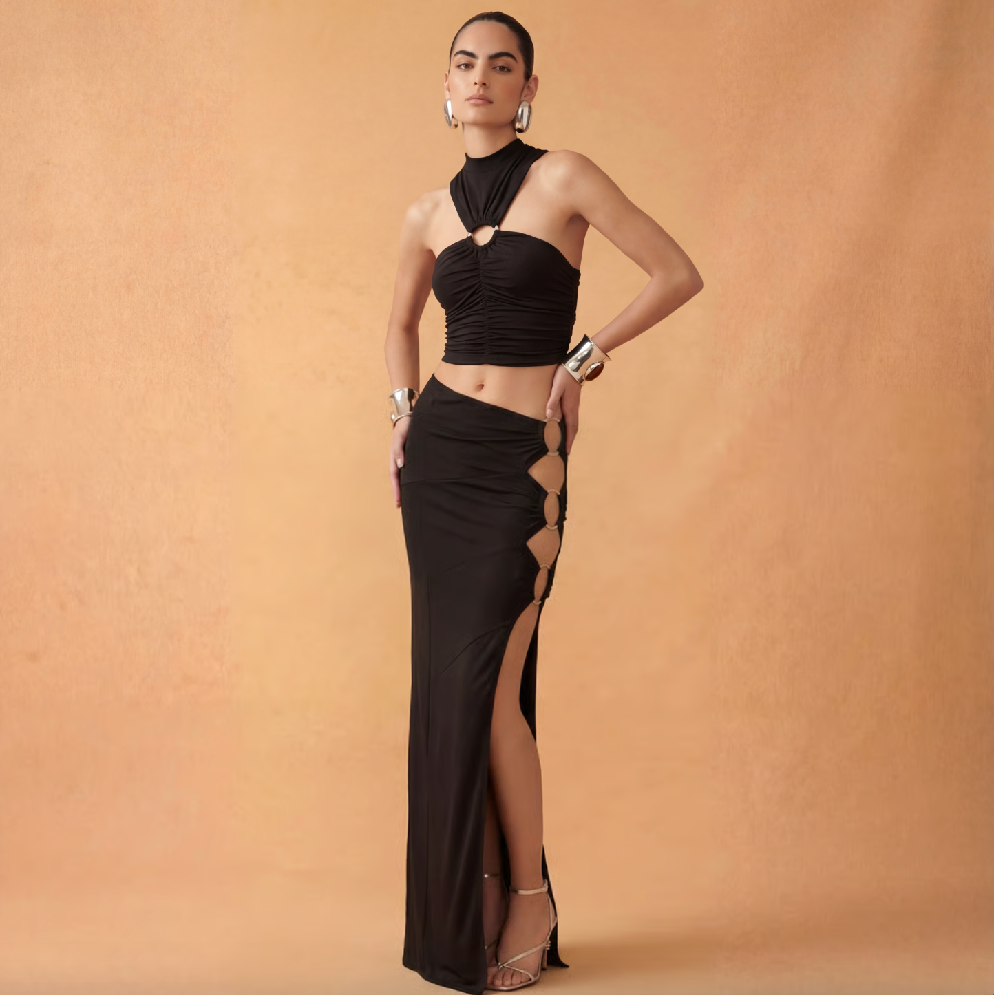 Woman wearing a black dress with cut-out design on a beige background